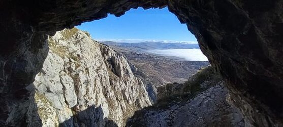 La Grotta dei Banditi ad Aielli (AQ). Immersa nel cuore del Parco Naturale Sirente-Velino, la Grotta dei Banditi ad Aielli (AQ) rappresenta uno degli angoli più misteriosi e affascinanti del territorio abruzzese. La sua posizione isolata, sopra le gole di Aielli e Celano, ha alimentato nel tempo leggende e racconti popolari che la vedono come rifugio di briganti e luogo di segreti incontri. L'ampia cavità rocciosa, nascosta tra la fitta vegetazione, ha offerto protezione e anonimato a coloro che vi si rifugiavano, rendendola un simbolo di storie avventurose e vita clandestina. La formazione della grotta risale a epoche geologiche molto antiche, quando l'azione dell'acqua ha iniziato a scavare la roccia calcarea, creando ambienti sotterranei modellati dai fenomeni carsici. Le infiltrazioni di pioggia e i movimenti della terra hanno modificato lentamente l'interno della cavità, dando vita a concrezioni e pareti levigate. Nonostante il trascorrere del tempo, la struttura della grotta conserva ancora le tracce di questo incessante processo naturale. L'accesso alla grotta è oggi reso difficoltoso da un accumulo di terra e dalla fitta vegetazione che ne cela l'ingresso. Al suo interno, la penombra avvolge ampie sale dove le pareti umide riflettono i riflessi della luce esterna, creando un'atmosfera surreale. Il silenzio interrotto solo dal gocciolio dell'acqua amplifica il senso di isolamento, contribuendo a mantenere intatta l'aura di mistero che circonda la grotta. La Grotta dei Banditi non è solo un luogo di interesse naturalistico, ma anche una testimonianza della storia locale e delle leggende che si intrecciano con il territorio. La sua riscoperta potrebbe rappresentare una preziosa opportunità per approfondire la conoscenza del paesaggio carsico e delle tradizioni popolari, restituendo a questo angolo nascosto il suo valore culturale e ambientale.