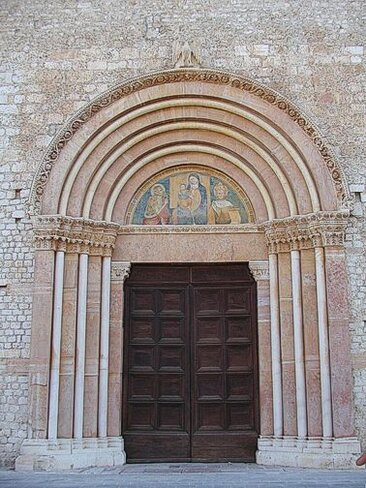 I luoghi sacri in Abruzzo: La Porta Santa a L’aquila. La Porta Santa de L'Aquila è un simbolo di fede e di tradizione religiosa che affonda le sue radici nel lontano 1294, quando Papa Celestino V istituì la Perdonanza, il primo Giubileo della cristianità. Questa straordinaria concessione di indulgenza venne stabilita con una Bolla papale, che offriva l'assoluzione da ogni pena e colpa a tutti coloro che, sinceramente pentiti e confessati, avessero visitato la basilica di Santa Maria di Collemaggio durante la ricorrenza annuale della Decollazione di San Giovanni Battista, dal vespro del 28 agosto al vespro del 29 agosto. Ogni anno, questa tradizione religiosa e spirituale viene celebrata con l’apertura della "Porta Santa", l’unica fuori Roma, dando così il via a una serie di riti e cerimonie che richiamano migliaia di fedeli e visitatori. L’apertura della Porta Santa avviene ogni anno la sera del 28 agosto, preceduta da un corteo storico che percorre le strade della città, partendo dal Palazzo Comunale e arrivando alla basilica di Collemaggio. Questo corteo, che coinvolge circa mille figuranti in costume d'epoca, rappresenta non solo il gruppo storico del Comune dell'Aquila, ma anche altre città italiane che partecipano a questo evento solenne. Un aspetto particolare della tradizione è che, sin dalla sua istituzione, la Perdonanza è stata indetta non dall'Arcivescovo, ma dal Sindaco dell'Aquila, in quanto la Bolla papale venne affidata all'autorità civile, che da allora custodisce gelosamente il documento. Tra i momenti più significativi della cerimonia vi è la figura della Dama della Bolla, che porta l’astuccio contenente il prezioso documento, fino al restauro della Bolla avvenuto nel 1997, quando il documento veniva ancora conservato all'interno dell’astuccio. Da allora, la Bolla è condotta separatamente alla basilica, come previsto dai restauratori, per preservarne la sua integrità. A fianco della Dama, c'è il Giovin Signore, che porta il ramo d'ulivo con cui il Cardinale, al culmine della cerimonia, percuote tre volte la Porta Santa, sancendo ufficialmente l'inizio delle festività. Questo gesto simbolico è carico di significato e rappresenta l’ingresso nella grazia e nel perdono divino. La Porta Santa de L'Aquila, oltre ad essere un elemento centrale della Perdonanza, è anche custode di simboli profondamente radicati nella tradizione abruzzese. Le chiavi della Porta, insieme al ramo d’ulivo e alla Bolla, sono conservati con grande solennità nel forziere della Torre Civica, dove sono protetti e custoditi con grande rispetto. Questo legame tra la città e il culto della Perdonanza non è solo un fatto religioso, ma un vero e proprio patrimonio culturale che, anno dopo anno, continua a rendere L'Aquila un centro spirituale di grande rilevanza per tutta la cristianità.