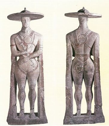 Il Guerriero di Capestrano Il Guerriero di Capestrano è una delle opere più iconiche e affascinanti dell’archeologia italica, conservata presso il Museo Archeologico Nazionale d’Abruzzo a Chieti. Questa imponente statua funeraria, alta circa 2,10 metri, risale al VI secolo a.C. ed è stata rinvenuta nel 1934 a Capestrano, un piccolo borgo nell’entroterra abruzzese. Realizzata in pietra calcarea locale, rappresenta un guerriero vestito di un’armatura elaborata, con un grande elmo decorato e dettagli che testimoniano la raffinatezza artistica e culturale delle antiche popolazioni italiche. La figura del Guerriero è imponente e carica di simbolismo. L’elmo a disco, che lo sovrasta, e il corpetto ornato indicano un ruolo di prestigio, forse quello di un capo o di un personaggio di alto rango sociale. Le braccia sono piegate in una posizione statica, e nella mano destra stringe una spada, mentre la sinistra sembra sorreggere uno scudo. Accanto al guerriero, una figura femminile più piccola, probabilmente una divinità o una personificazione, arricchisce l’opera di significati religiosi e rituali, tipici delle credenze delle popolazioni sannitiche o vestine. Il significato del Guerriero di Capestrano va oltre la sua imponenza fisica. È un simbolo di identità culturale e storica per l’Abruzzo e una testimonianza unica della civiltà italica prima dell’arrivo dei Romani. La statua rivela l’importanza attribuita alla guerra, al prestigio sociale e alla ritualità nella società antica, e le sue fattezze stilizzate lo distinguono da altre sculture dell’epoca, rendendolo un esempio unico di arte funeraria pre-romana. Alcuni studiosi ipotizzano che il Guerriero rappresentasse non solo un individuo, ma anche un ideale di forza e protezione per la comunità. Oggi, il Guerriero di Capestrano è un punto di riferimento per l’archeologia e la cultura abruzzese, attirando l’attenzione di studiosi e visitatori da tutto il mondo. Esso incarna il legame tra il passato e il presente, raccontando storie di antiche genti che hanno plasmato l’identità del territorio. Ammirarlo da vicino significa compiere un viaggio nel tempo, scoprendo non solo l’abilità artistica delle antiche popolazioni italiche, ma anche il valore intrinseco delle loro tradizioni, ancora vive nel patrimonio culturale dell’Abruzzo.