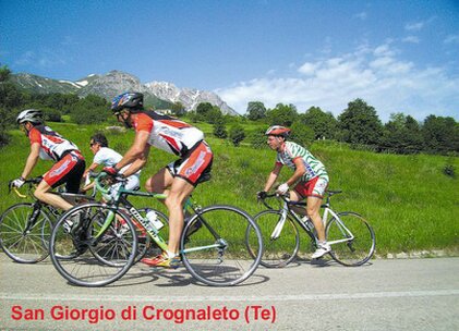 Pedalare sulle montagne dell’Abruzzo significa vivere un’esperienza a stretto contatto con una natura autentica e sorprendentemente varia, attraversando paesaggi in cui il verde dei boschi si alterna ai pascoli, alle vallate e alle imponenti cime dell’Appennino. In sella alla bicicletta, il viaggio assume un ritmo lento e naturale, ideale per apprezzare ogni dettaglio del territorio e lasciarsi sorprendere da panorami che cambiano a ogni curva. Le strade che attraversano il Gran Sasso, la Majella e le altre aree montane della regione conducono tra boschi rigogliosi, altopiani e piccoli borghi, offrendo itinerari adatti a chi desidera unire attività sportiva, scoperta del paesaggio e momenti di autentico relax. Lontano dal traffico delle grandi città, il silenzio della montagna accompagna la pedalata e permette di vivere pienamente la bellezza di un ambiente ancora profondamente legato ai suoi ritmi naturali, con la possibilità di incontrare lungo il percorso testimonianze della storia e delle tradizioni delle comunità locali. Il cicloturismo in montagna offre inoltre l’opportunità di conoscere un Abruzzo più intimo, fatto di strade panoramiche, antichi sentieri e piccoli centri immersi nel paesaggio. Ogni itinerario può trasformarsi in un viaggio alla scoperta della biodiversità della regione, tra faggete, vallate verdi e ambienti d’alta quota, dove la presenza di numerose aree protette contribuisce a preservare un patrimonio naturale di grande valore. Le salite richiedono impegno e costanza, ma vengono ricompensate da panorami spettacolari e dalla soddisfazione di raggiungere luoghi lontani dai percorsi più affollati. Pedalare tra le montagne abruzzesi significa così alternare movimento e contemplazione, sport e natura, scoprendo lentamente un territorio capace di offrire emozioni diverse in ogni stagione. È un modo sostenibile per esplorare l’entroterra, valorizzare i piccoli borghi e vivere la montagna attraverso un’esperienza autentica, in cui ogni chilometro diventa parte di un viaggio immerso nel verde.
